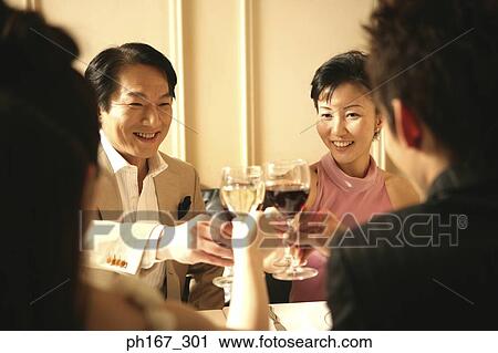 Two couples making a toast with wine View Large Photo Image Stock Image - Two couples making a toast with wine. Fotosearch
