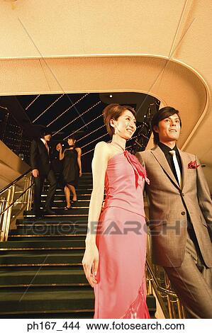 Picture - Two couples walking down steps of cruise ship. Fotosearch