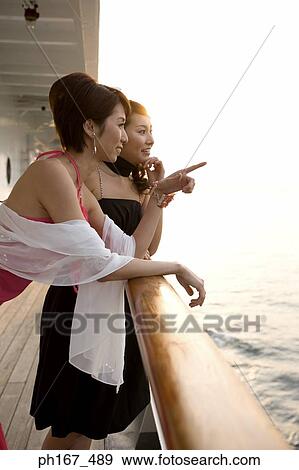Stock Photo - Two women enjoying the view onboard a cruise ship. Fotosearch