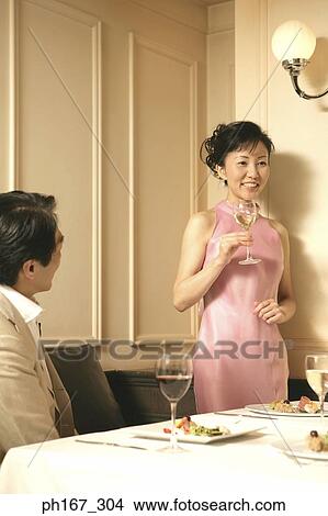 Woman making a toast in a restaurant View Large Photo Image Picture - Woman making a toast in a restaurant. Fotosearch
