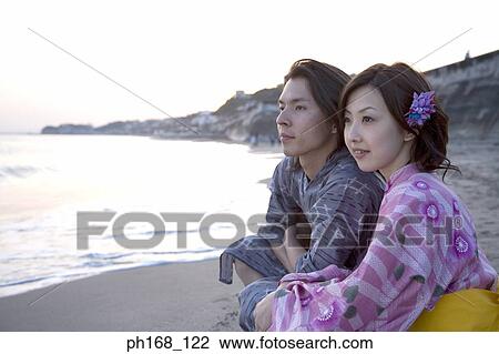 Couple at the beach during sunset View Large Photo Image Stock Image - Couple at the beach during sunset. Fotosearch