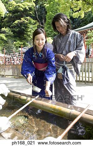 Couple in traditional Japanese clothing cleansing themselves at temple View Large Photo Image Stock Image - Couple in traditional Japanese clothing cleansing themselves at temple. Fotosearch