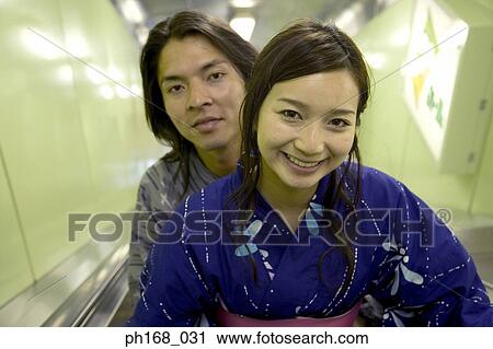 Couple in traditional Japanese clothing on an escalator View Large Photo Image Stock Image - Couple in traditional Japanese clothing on an escalator. Fotosearch