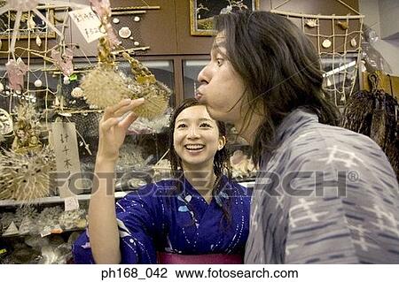 Couple in traditional Japanese clothing having fun in souvenir shop View Large Photo Image Stock Image - Couple in traditional Japanese clothing having fun in souvenir shop. Fotosearch