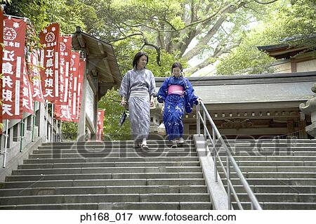 Stock Photo - Couple in traditional Japanese clothing walking down steps. Fotosearch