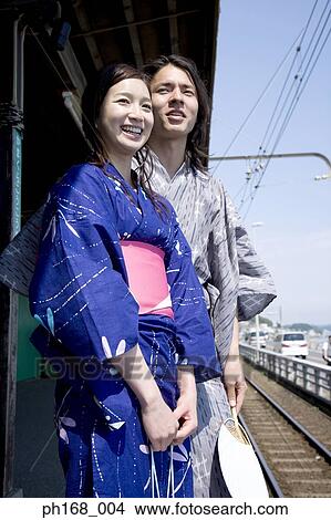 Couple waiting for train in traditional Japanese clothing View Large Photo Image Picture - Couple waiting for train in traditional Japanese clothing. Fotosearch