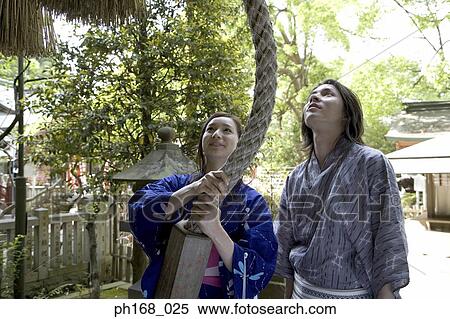 Man watching woman in kimono, pulling rope View Large Photo Image Stock Photography - Man watching woman in kimono, pulling rope . Fotosearch