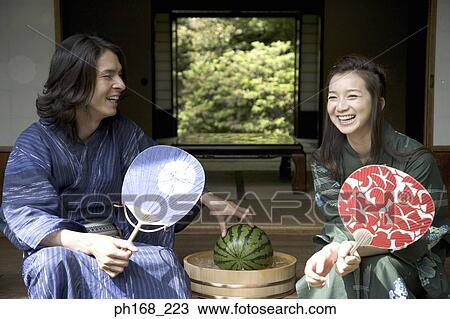 Couple in traditional Japanese clothing sitting by corridor with water melon View Large Photo Image Stock Image - Couple in traditional Japanese clothing sitting by corridor with water melon. Fotosearch