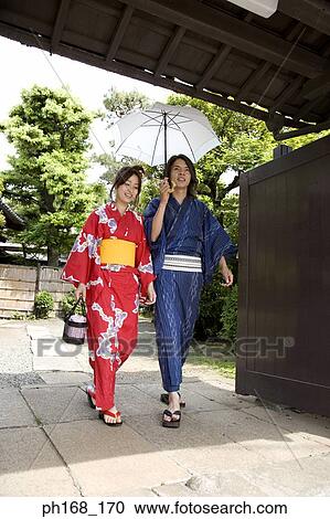 Stock Image - Couple in traditional Japanese clothing, walking. Fotosearch