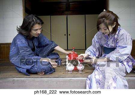 Stock Image - Couple making dessert by corridor. Fotosearch