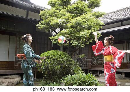 Two women in kimono having fun in the garden View Large Photo Image Stock Image - Two women in kimono having fun in the garden. Fotosearch