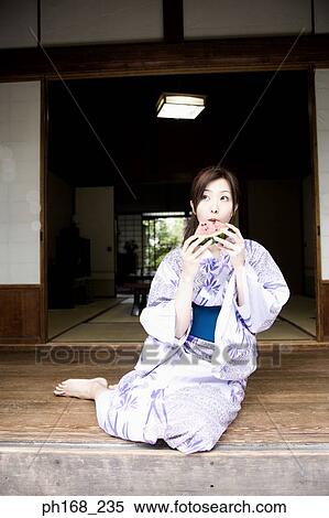 Woman in kimono biting into water melon View Large Photo Image Stock Photography - Woman in kimono biting into water melon. Fotosearch