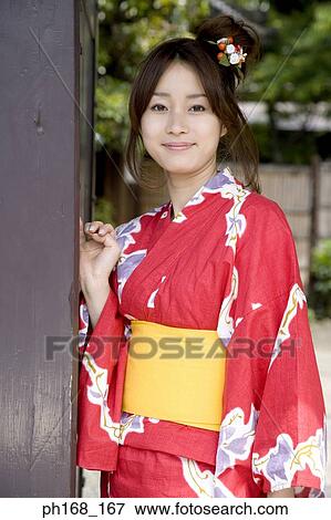 Woman in kimono leaning against a pillar View Large Photo Image Stock Photo - Woman in kimono leaning against a pillar. Fotosearch