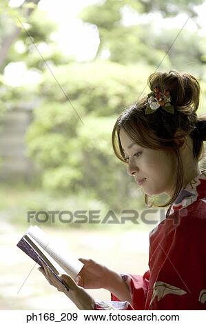 Woman in kimono reading a book View Large Photo Image Stock Photo - Woman in kimono reading a book. Fotosearch