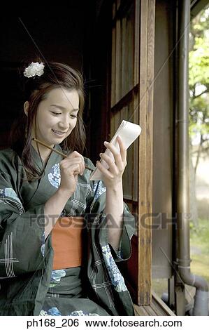 Woman in kimono writing by the corridor View Large Photo Image Stock Photograph - Woman in kimono writing by the corridor. Fotosearch
