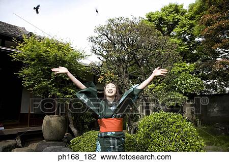 Woman in the garden, with hands outstretched View Large Photo Image Stock Image - Woman in the garden, with hands outstretched. Fotosearch