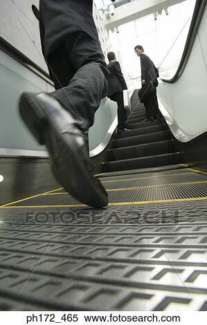 Close-up of businessman's feet on escalator View Large Photo Image Stock Photography - Close-up of businessman's feet on escalator. Fotosearch
