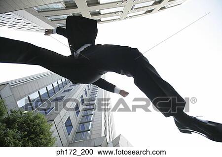 Executive jumping, low angle view View Large Photo Image Stock Image - Executive jumping, low angle view. Fotosearch