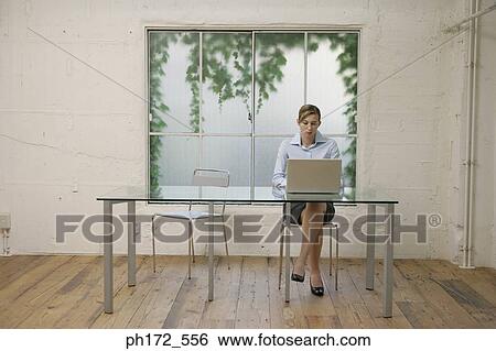 Female executive working on laptop View Large Photo Image Stock Photograph - Female executive working on laptop. Fotosearch