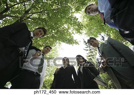 Group of executive standing in park, low angle view View Large Photo Image Stock Image - Group of executive standing in park, low angle view. Fotosearch