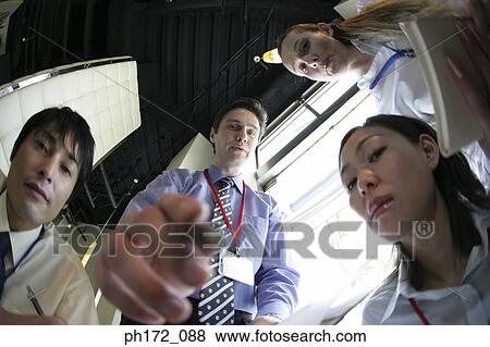 Group of executives having discussion in boardroom, fish-eye, low angle view View Large Photo Image Stock Photo - Group of executives having discussion in boardroom, fish-eye, low angle view. Fotosearch
