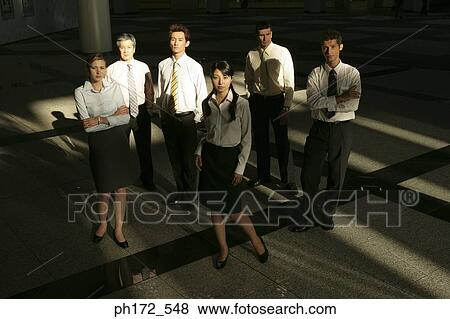 Stock Photo - Group of executives standing in lobby. Fotosearch