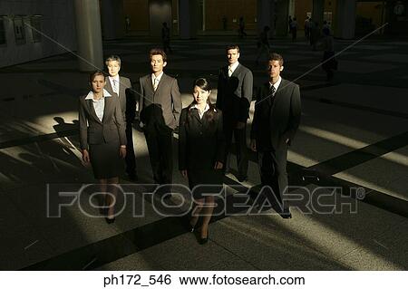 Stock Photograph - Group of executives standing in lobby. Fotosearch