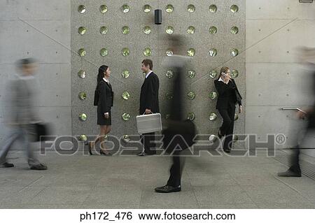 Three executives standing by wall View Large Photo Image Stock Photograph - Three executives standing by wall. Fotosearch