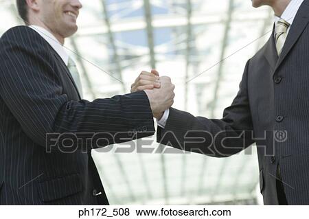Two businessmen shaking hands View Large Photo Image Stock Photo - Two businessmen shaking hands. Fotosearch