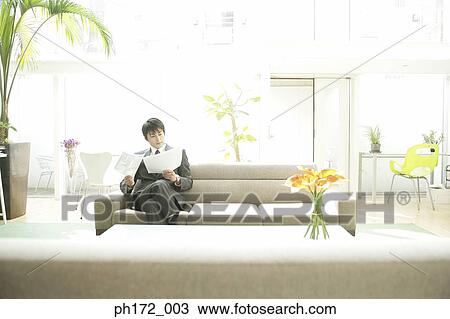 Businessman sitting on sofa View Large Photo Image Stock Image - Businessman sitting on sofa. Fotosearch