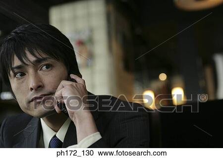 Businessman using a mobile phone View Large Photo Image Stock Image - Businessman using a mobile phone. Fotosearch