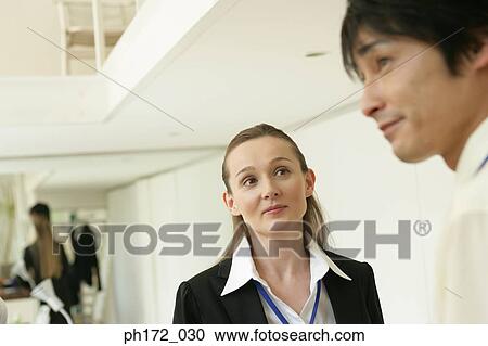 Close-up of businessman and female colleague View Large Photo Image Stock Image - Close-up of businessman and female colleague. Fotosearch