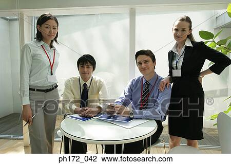 Stock Image - Group of business people in office. Fotosearch