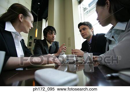 Stock Photography - Group of executives having discussion. Fotosearch