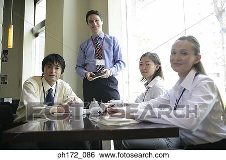 Group of executives in boardroom close-up View Large Photo Image Stock Photograph - Group of executives in boardroom close-up. Fotosearch