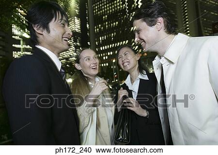 Group of executives standing and laughing, night View Large Photo Image Stock Image - Group of executives standing and laughing, night. Fotosearch