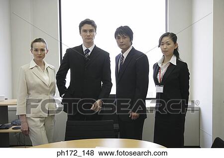 Group of executives standing in a board room View Large Photo Image Stock Photo - Group of executives standing in a board room. Fotosearch