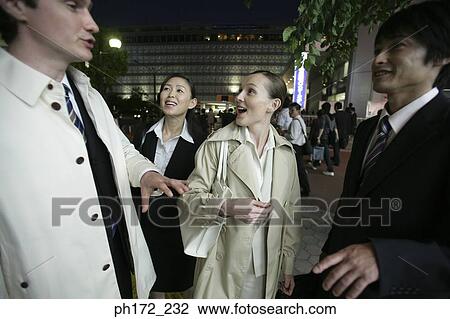 Group of executives standing on the street at night View Large Photo Image Stock Image - Group of executives standing on the street at night. Fotosearch