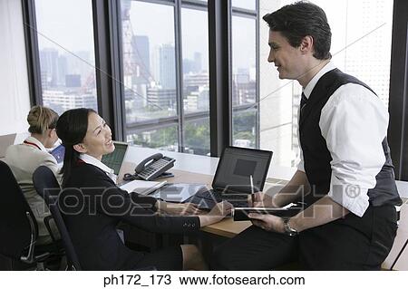 Group of executives working in office View Large Photo Image Stock Image - Group of executives working in office. Fotosearch