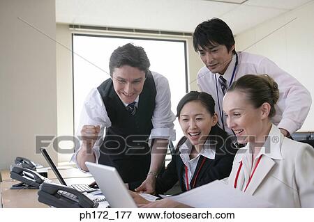 Stock Photo - Group of executives working in office. Fotosearch