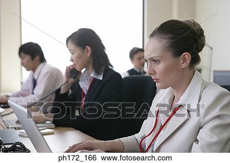 Group of executives working in office View Large Photo Image Stock Photograph - Group of executives working in office. Fotosearch