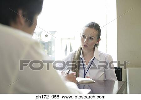 Stock Photo - Two executives having discussion in boardroom. Fotosearch