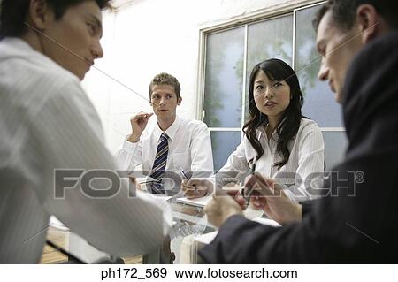 Group of executives having a discussion View Large Photo Image Stock Photo - Group of executives having a discussion. Fotosearch