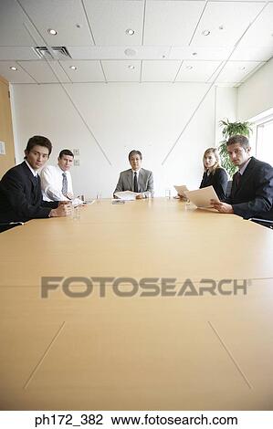 Group of executives in a board room meeting View Large Photo Image Stock Image - Group of executives in a board room meeting. Fotosearch