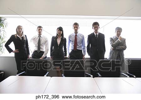 Stock Photograph - Group of executives standing in board room. Fotosearch