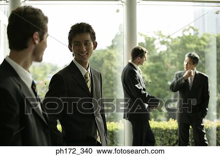 Group of male executives chatting View Large Photo Image Stock Image - Group of male executives chatting. Fotosearch