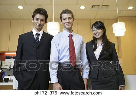 Stock Photograph - Portrait of three executives smiling. Fotosearch