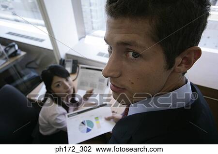 Stock Image - Two executives in office, high angle view. Fotosearch