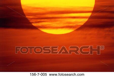 Stock Photography - Warmth, Sunrise, Backgrounds, Clouds, Sun, Planet. Fotosearch