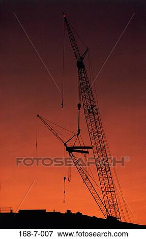 Stock Photo - Cranes, Daylight, Day, Outdoors, Sunrise, Construction, Site. Fotosearch
